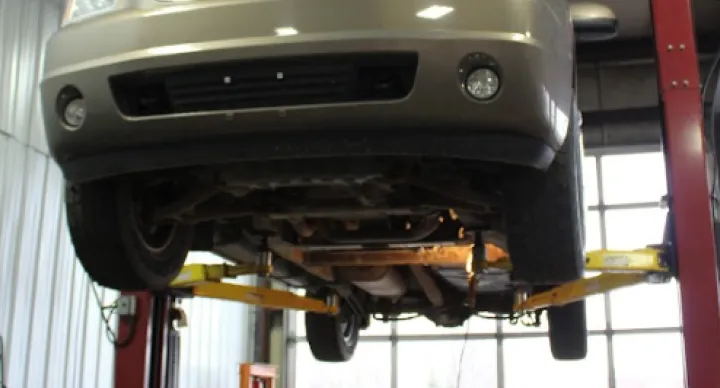 Steering & Suspension Repair In Grand Blanc Township, MI At Grand Pointe Automotive. Car lifted for maintenance inspection
