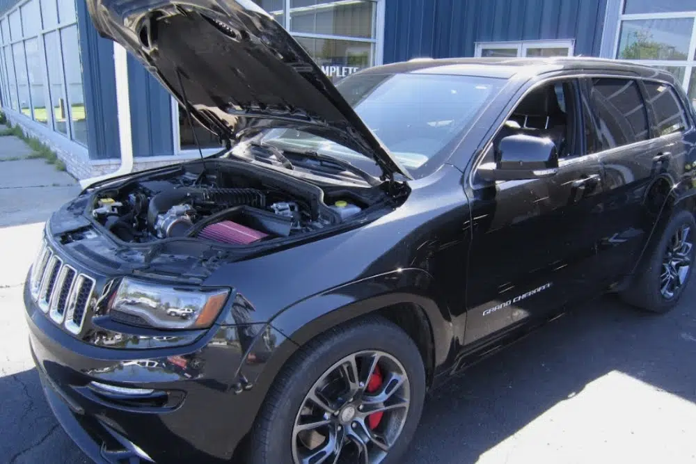 Black SUV with hood open