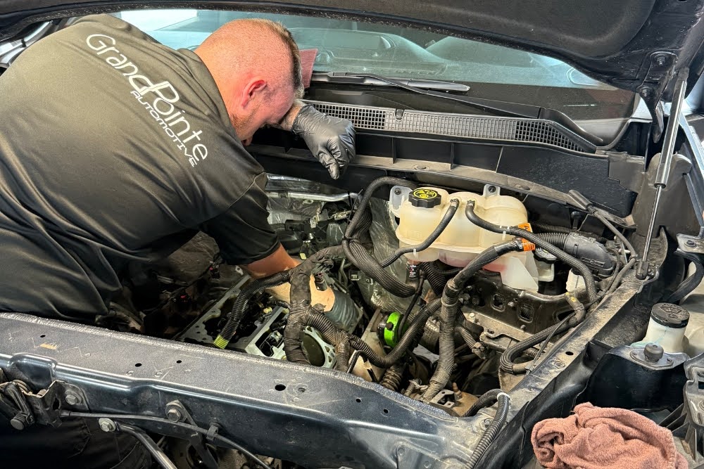 Mechanic working on car engine