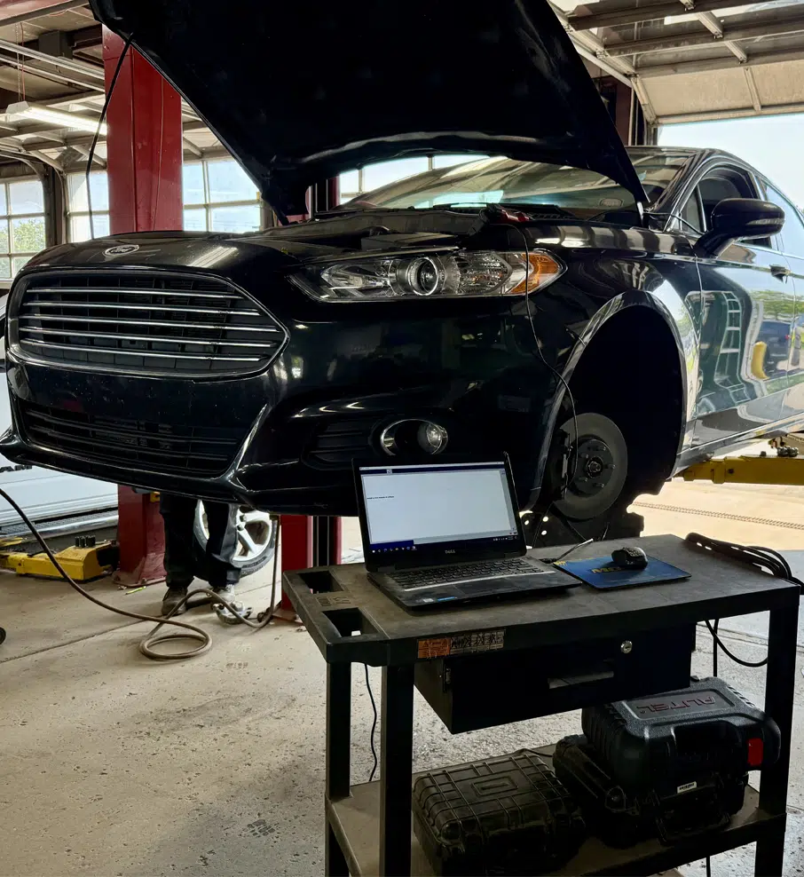 Auto Repair In Grand Blanc Township, MI At Grand Pointe Automotive. Car on lift with diagnostic equipment