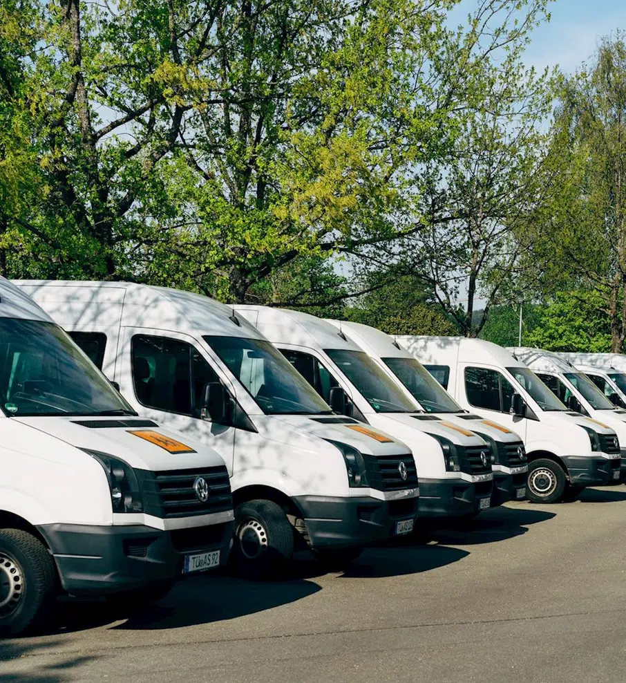 Fleet Maintenance In Grand Blanc Township, MI At Grand Pointe Automotive. Row of white delivery vans