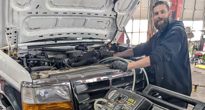 Preventative Maintenance In Grand Blanc Township, MI At Grand Pointe Automotive. Person working on vehicle engine