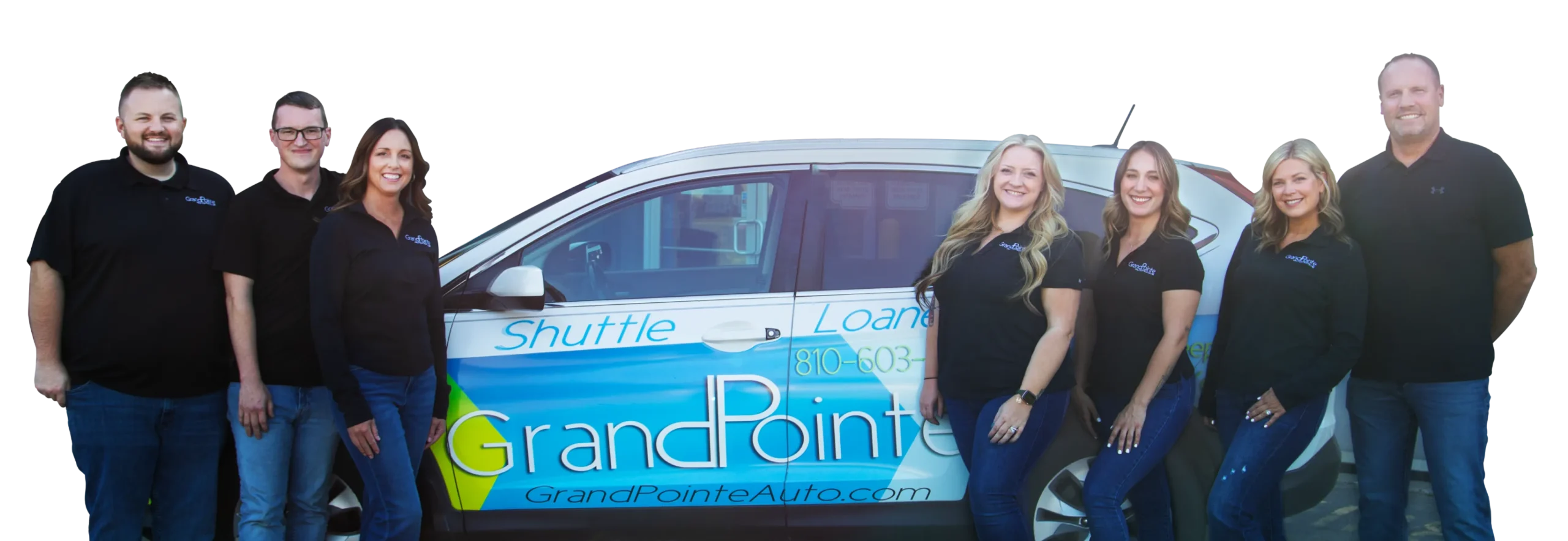 Team posing beside branded vehicle.