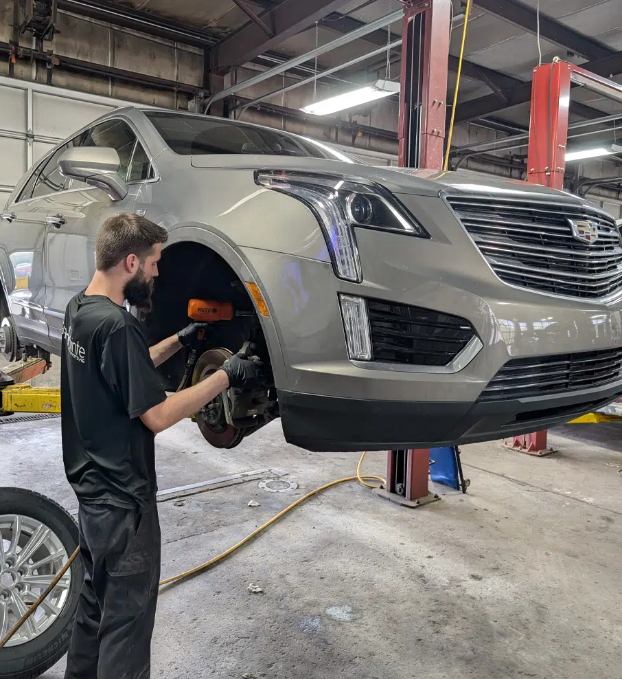 Steering & Suspension In Grand Blanc Township, MI At Grand Pointe Automotive. Mechanic working on car suspension