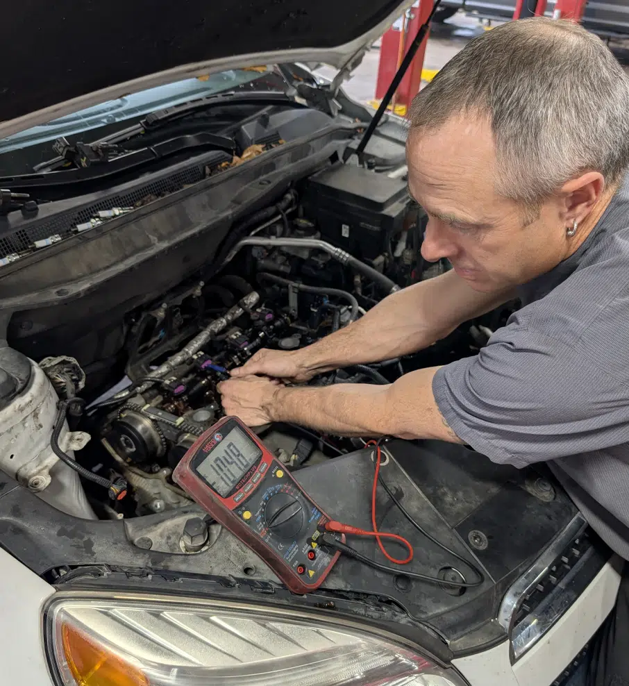 Mechanic working on engine diagnostics.