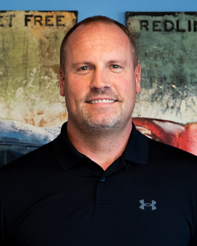 Aaron Klosterman, Owner of Auto repair shop In Grand Blanc Township, MI At Grand Pointe Automotive. Man in black polo shirt