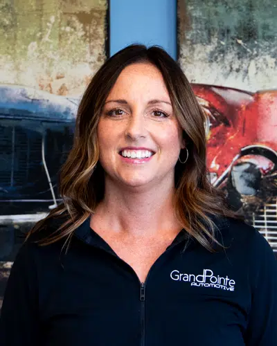 Courtney Pinkelman - Finance/HR Manager At Grand Pointe Automotive in Grand Blanc MI. Woman in automotive-themed setting.