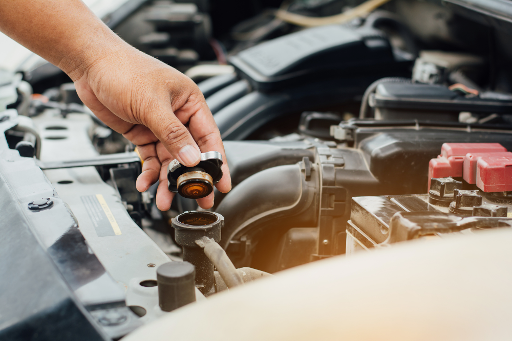 Coolant System Repair in Grand Blanc Township MI at Grand Pointe Automotive. Close-up view of a coolant reservoir cap on a vehicle