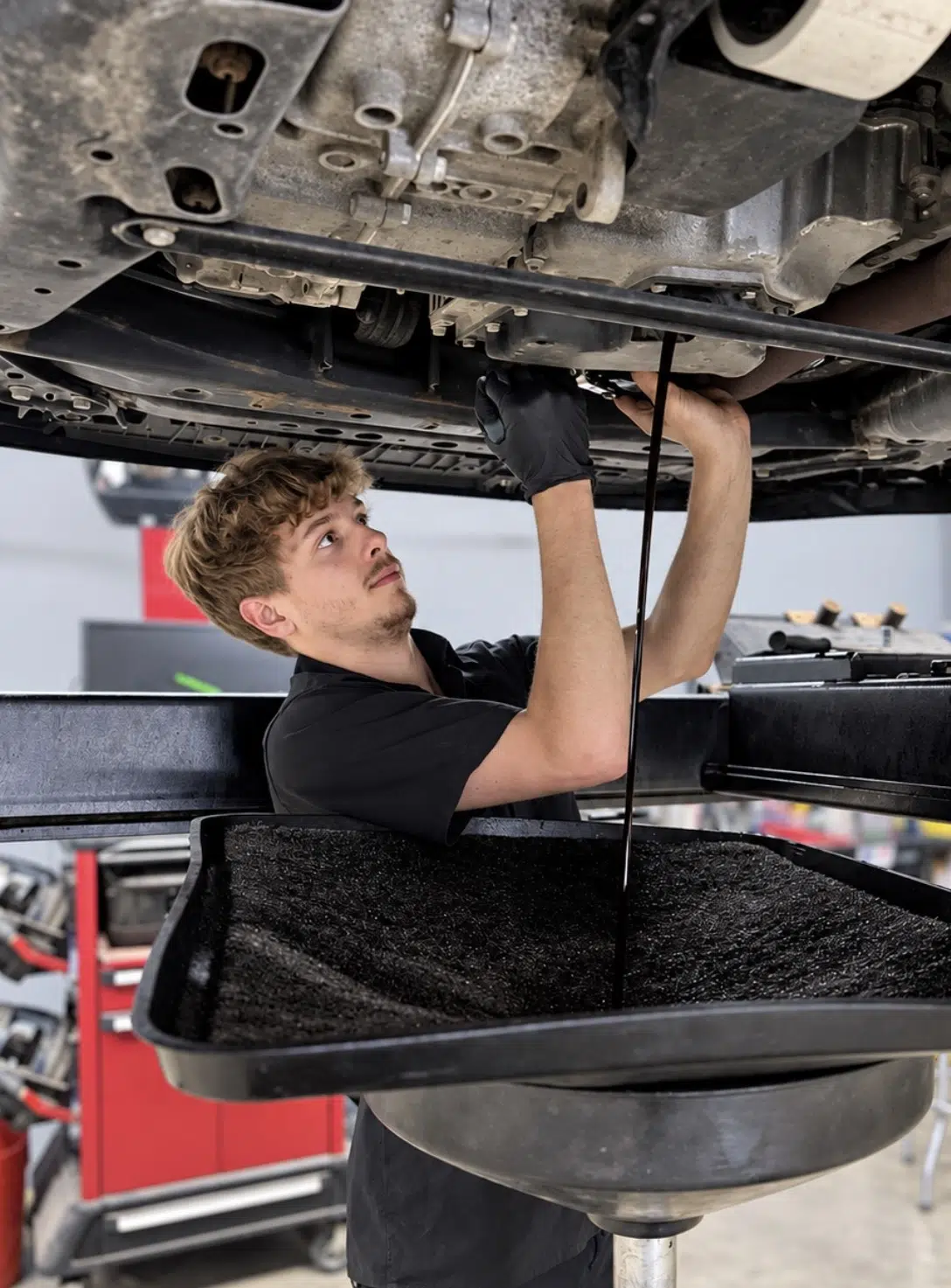 Oil Change In Grand Blanc Township, MI At Grand Pointe Automotive. Mechanic working on car engine